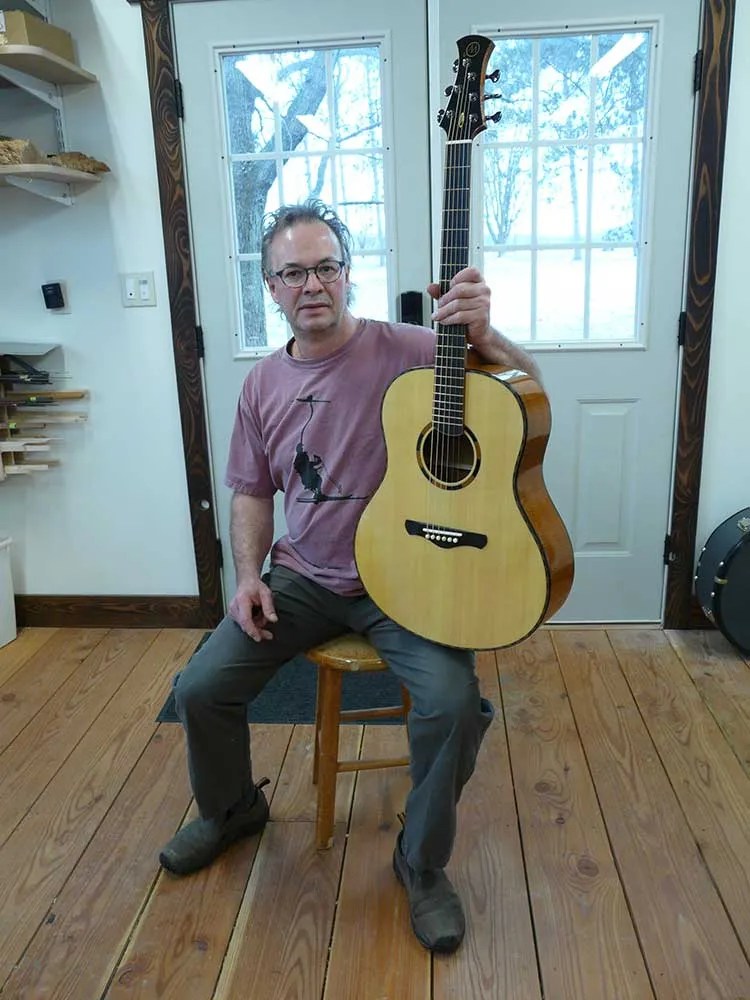 Luthier Randy Muth holding a classical guitar