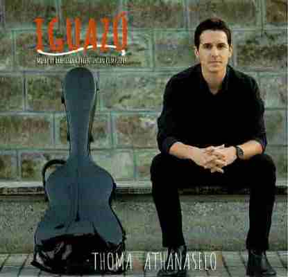 The cover of classical guitarist Thomas Athanaselos’ album Iguazu. Athanaselos sits on a bench next to his guitar case.