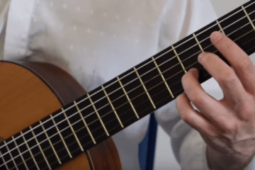 closeup of left hand holding guitar chord for Classical Guitar Lesson Tarrega Recuerdos de la Alhambra
